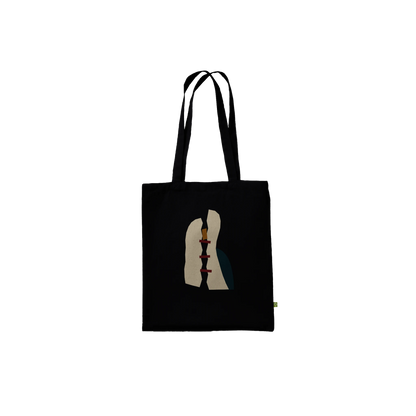 Front view of THE MENDING black cotton tote featuring fractured ivory planes joined by three oxblood bars.
