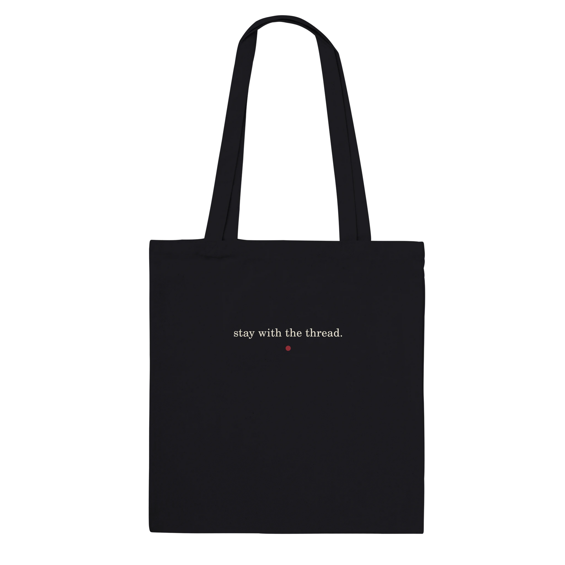 Back of THE THREAD tote featuring the words stay with the thread in ivory lettering.