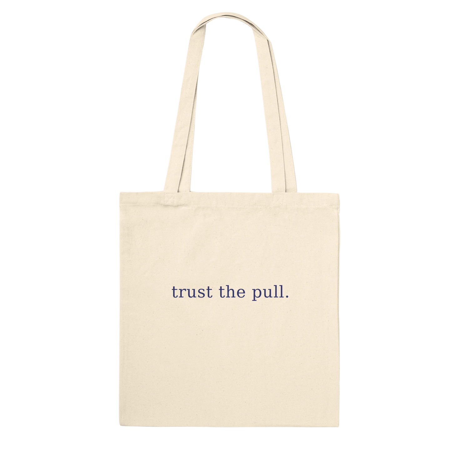 Rear view of THE PULL tote showing the words trust the pull on natural cotton.