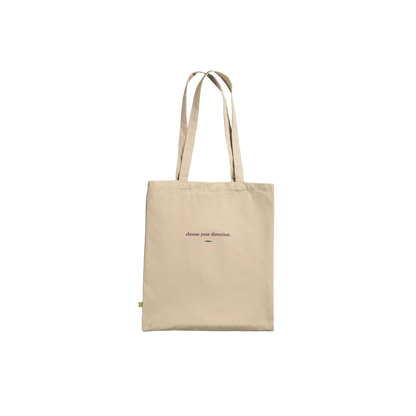Back of THE TURN natural cotton tote featuring the words choose your direction in small serif lettering.