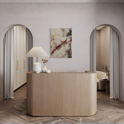 What Remains textured canvas art displayed behind a curved reception console in a refined interior.