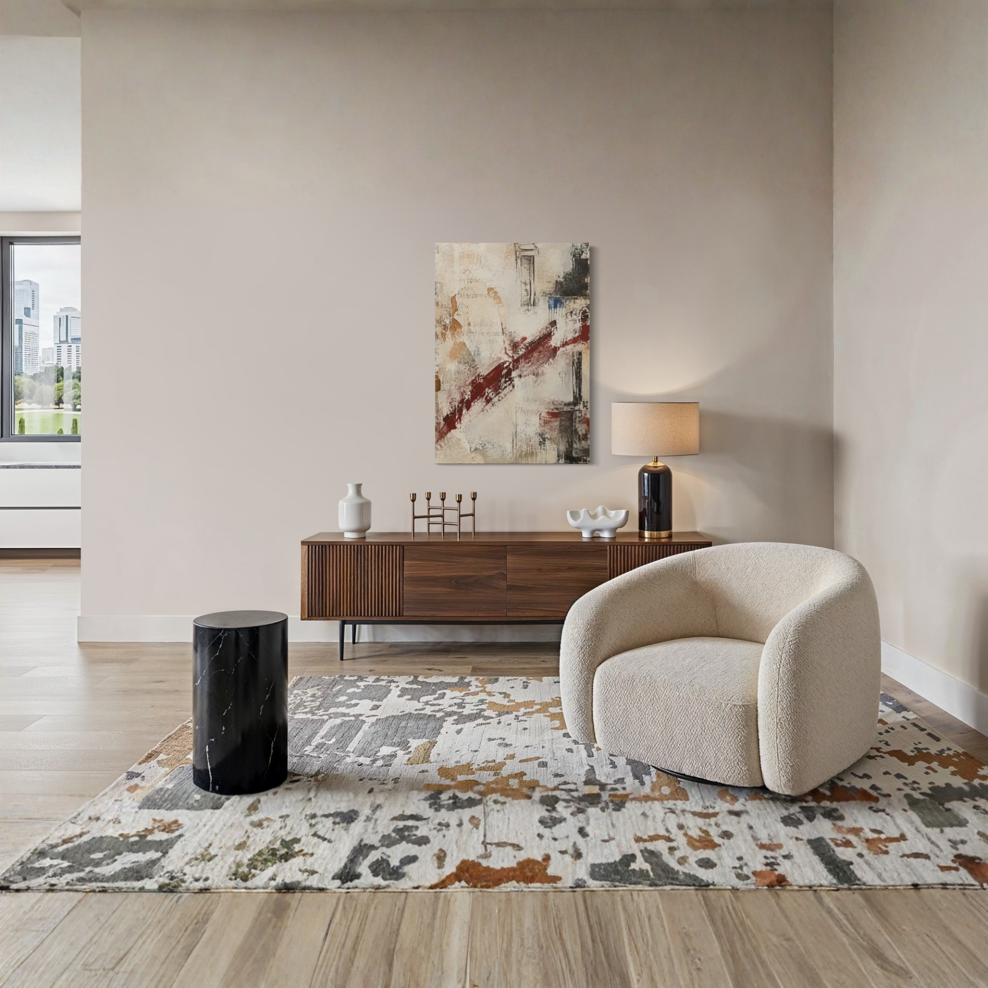 What Remains textured abstract canvas styled above a cream armchair in a quiet contemporary interior.
