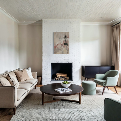 The Unsaid abstract canvas art displayed above a neutral sofa in a bright contemporary space.