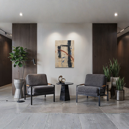 Boundary abstract canvas art displayed between two dark armchairs in a refined modern interior with dark wood panels and greenery.