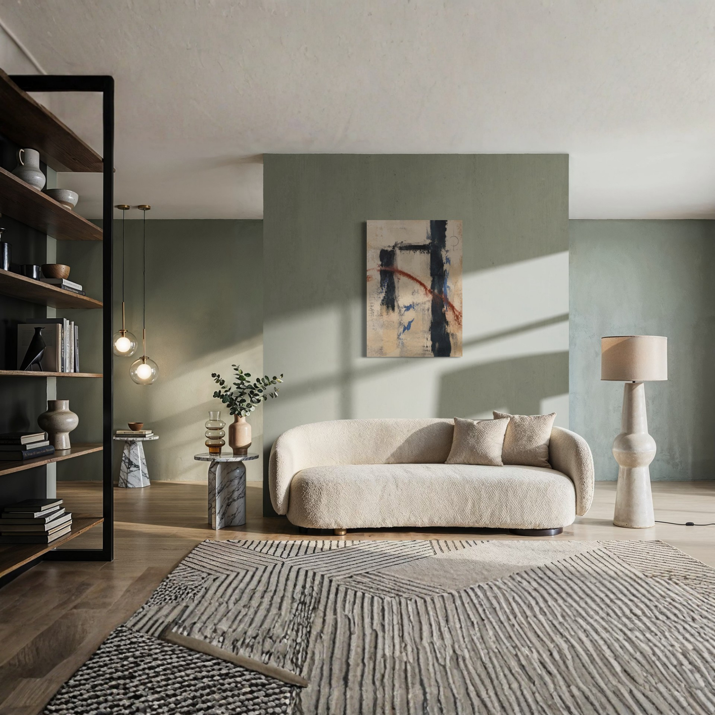 Boundary abstract canvas art displayed above a curved cream sofa in a refined sage green living room.