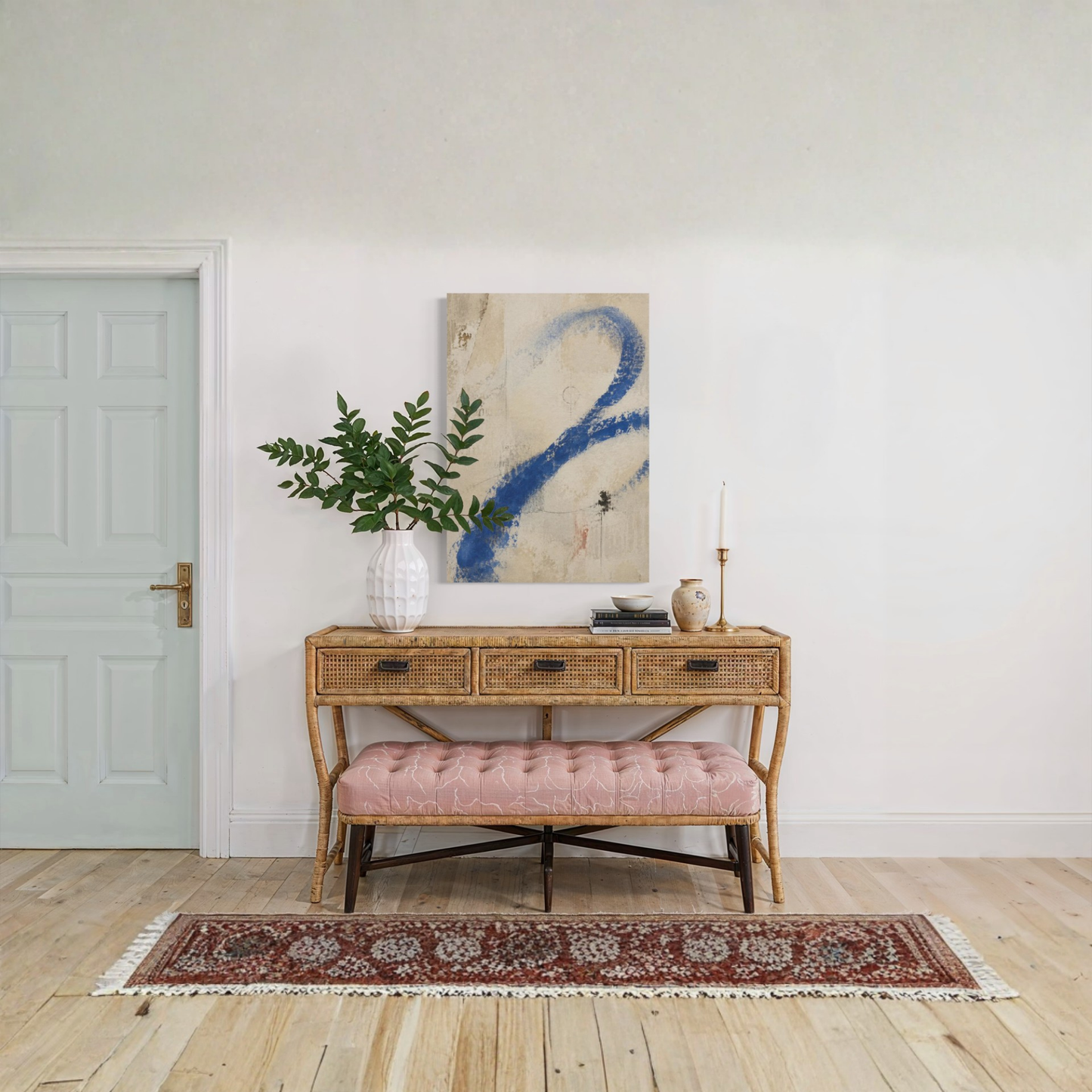 Proof of Life abstract wall art styled above a wooden console with greenery and a patterned rug.