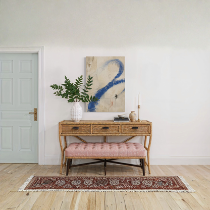 Proof of Life abstract wall art styled above a wooden console with greenery and a patterned rug.
