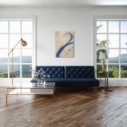 Proof of Life cobalt blue canvas displayed above a dark blue sofa in a bright room with large windows.