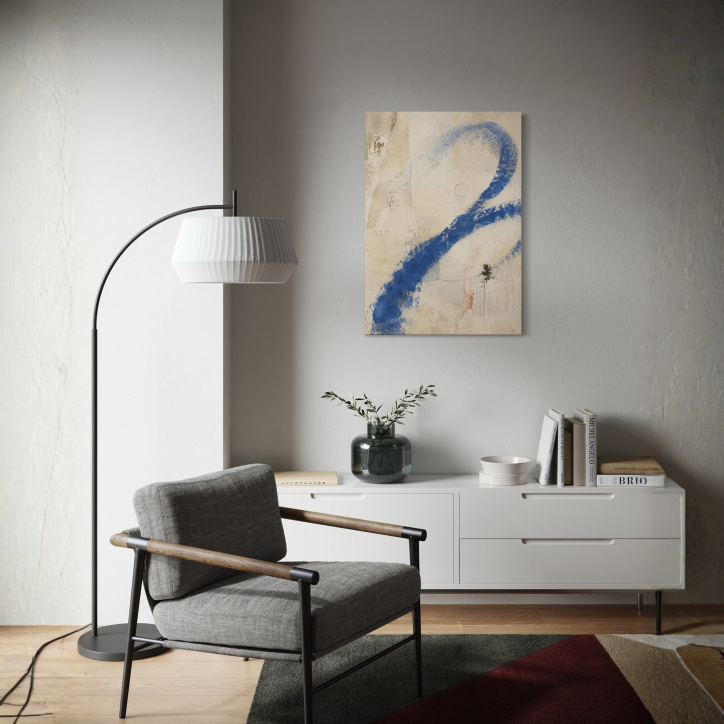 Proof of Life blue abstract canvas displayed above a white sideboard beside a dark armchair in a refined modern interior.