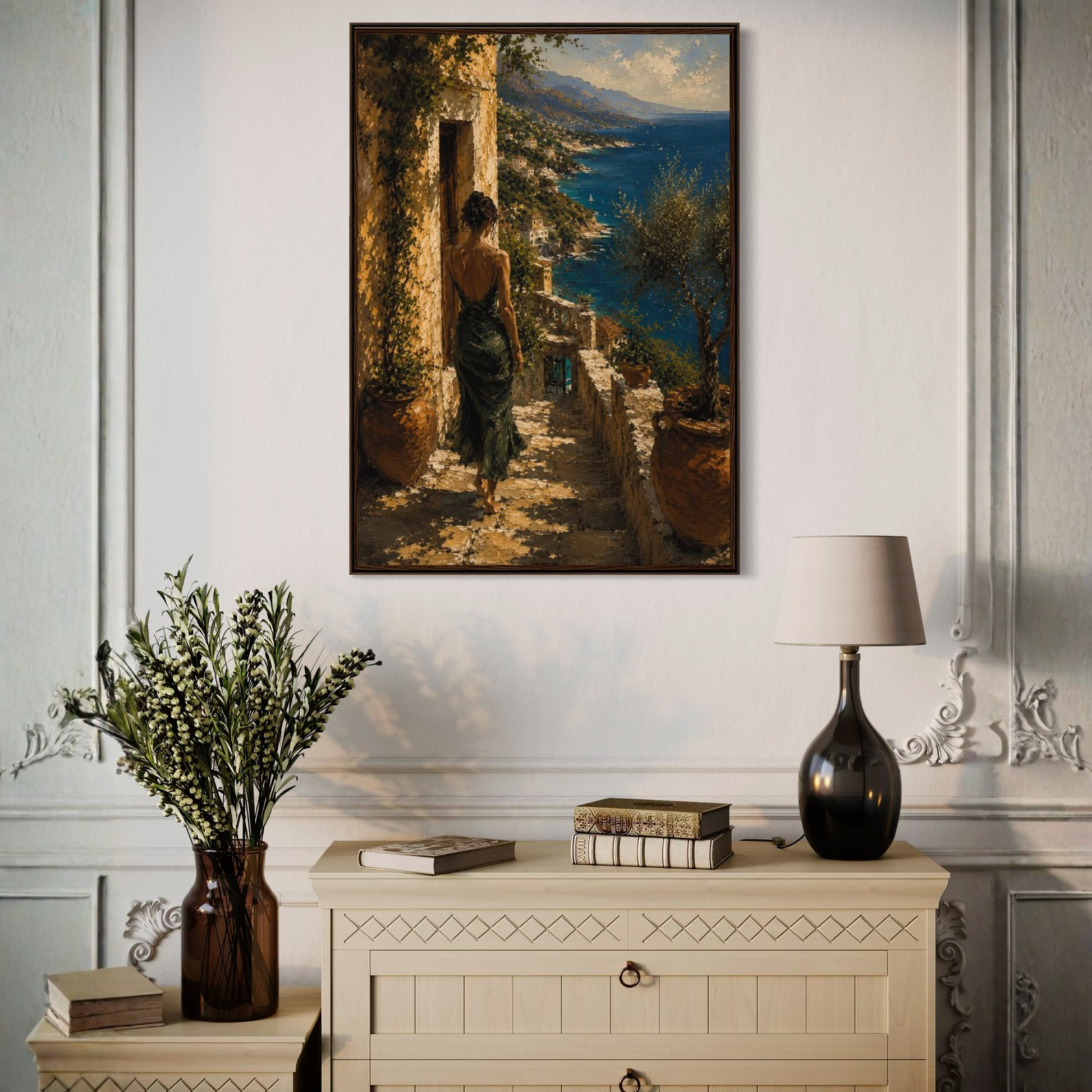 Mediterranean framed painting of a woman on a staircase with a scenic view, above a decorative cabinet with a lamp and books.