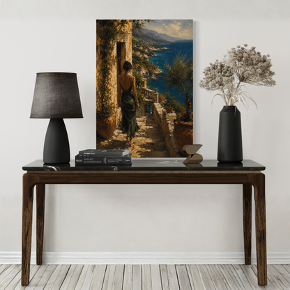 Decorative table with a lamp, books, and a vase in front of a large Mediterranean wall art of a woman by the sea.