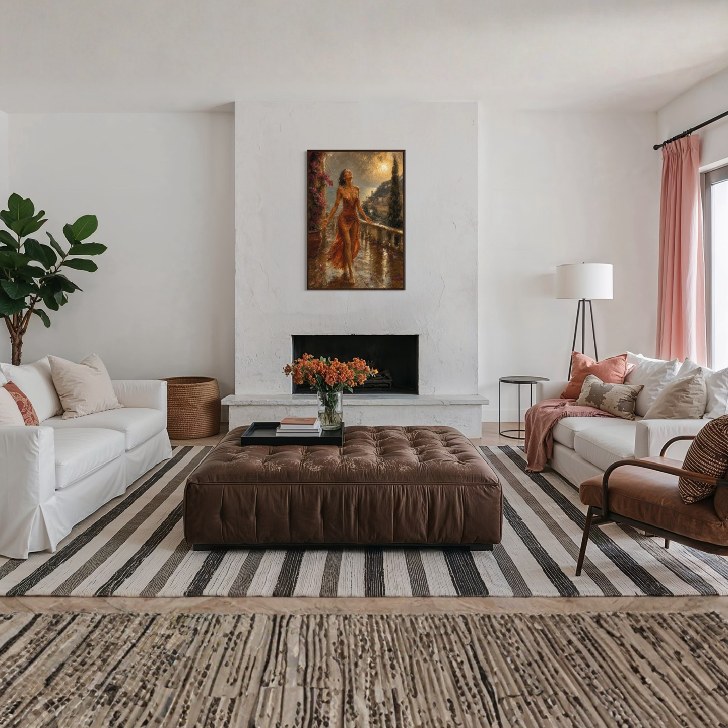 A styled living room interior featuring a large brown tufted leather ottoman centered on a black and white striped area rug. The room includes a white sofa on the left, a white sofa with pink pillows on the right, a brown armchair, a fireplace with The Sunshower Mediterranean framed art print displayed in a dark wood frame.