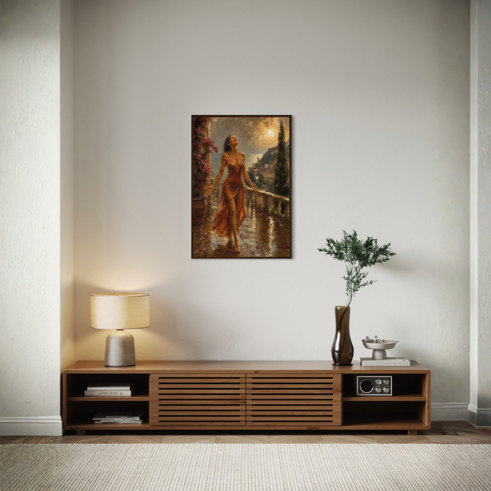 The Sunshower Mediterranean framed art print in a dark wood frame displayed on a light gray wall above a wooden console table in a styled room setting.