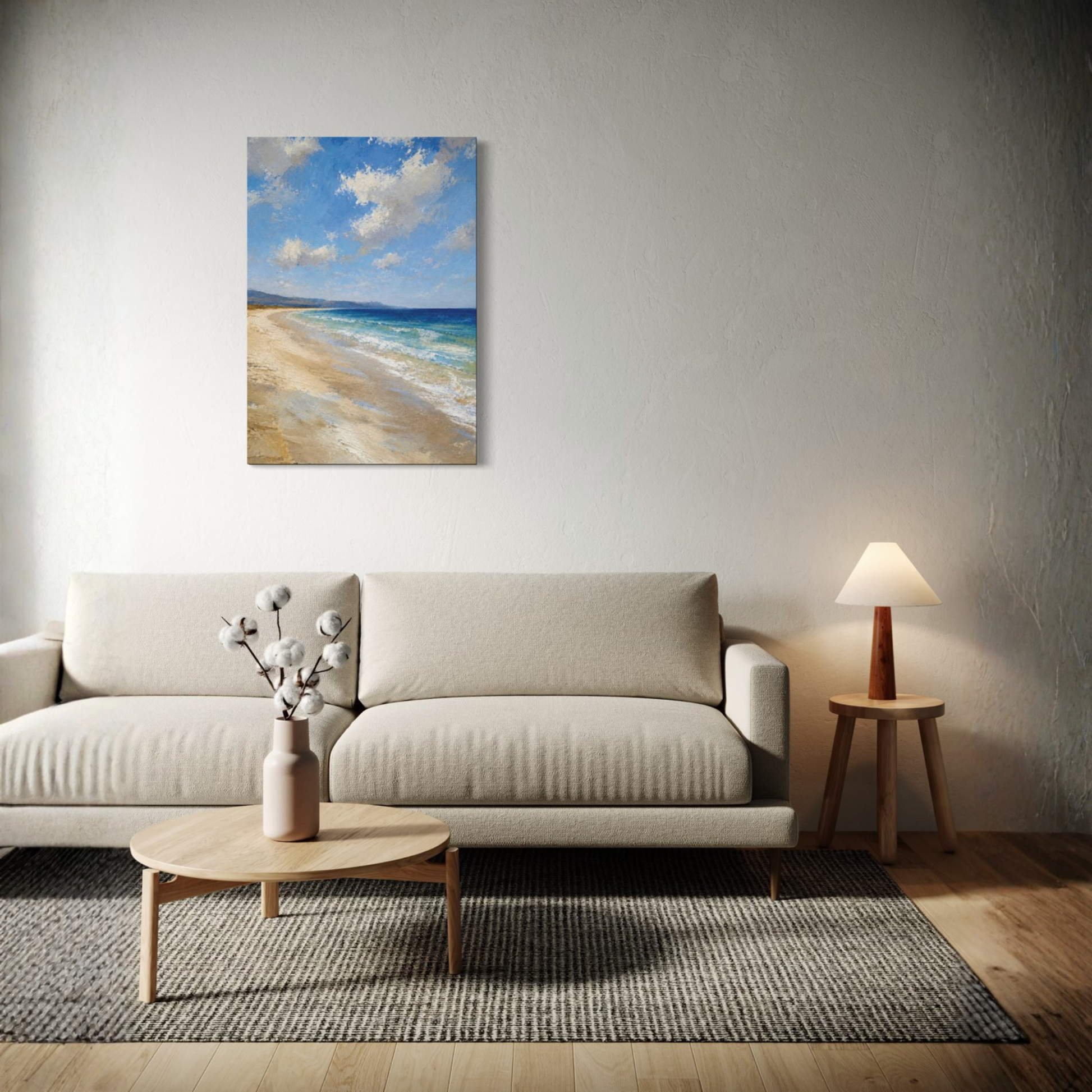 The Blue Distance Mediterranean canvas art hangs on a textured light gray wall above a modern beige sofa in a styled living room setting.
