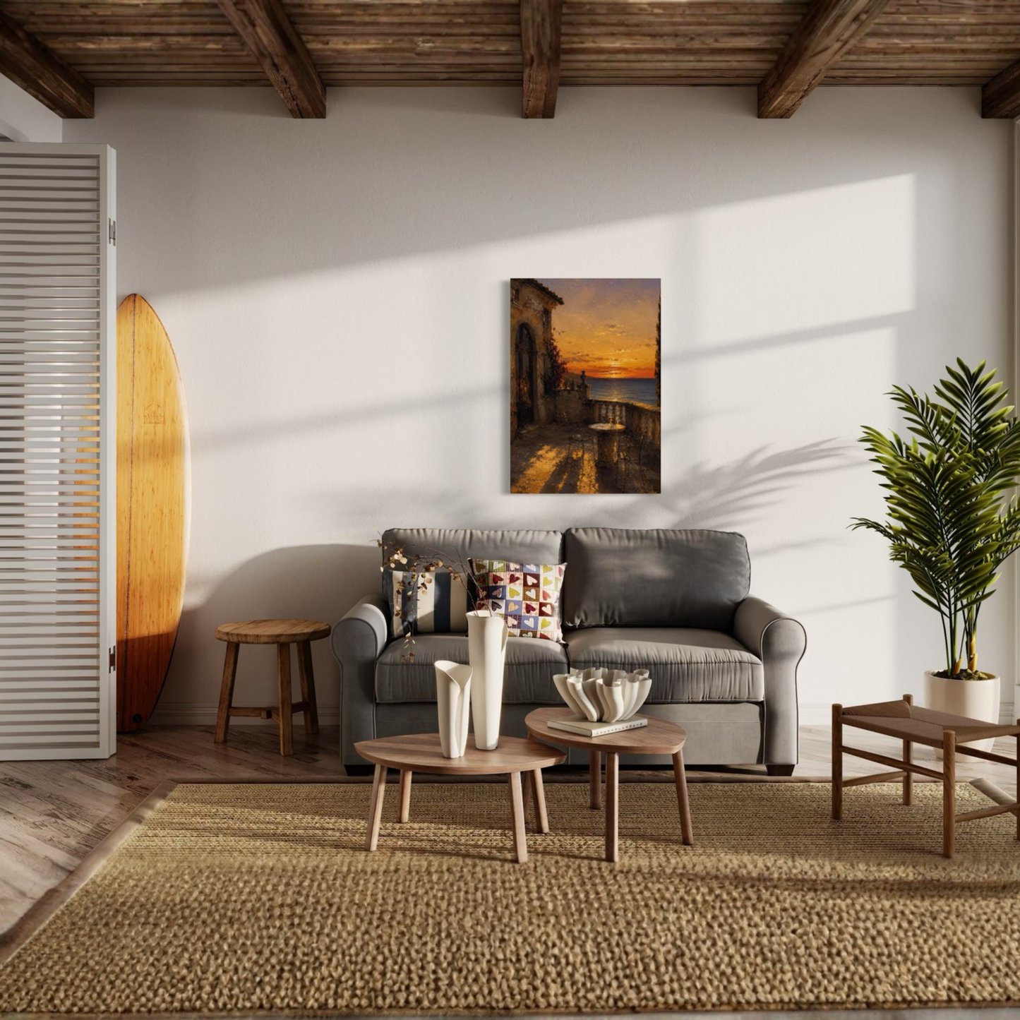 The Hour Mediterranean canvas art in a styled living room. The room features a gray sofa, two wooden coffee tables, a large woven jute rug, a potted palm, and a wooden surfboard leaning against the wall.