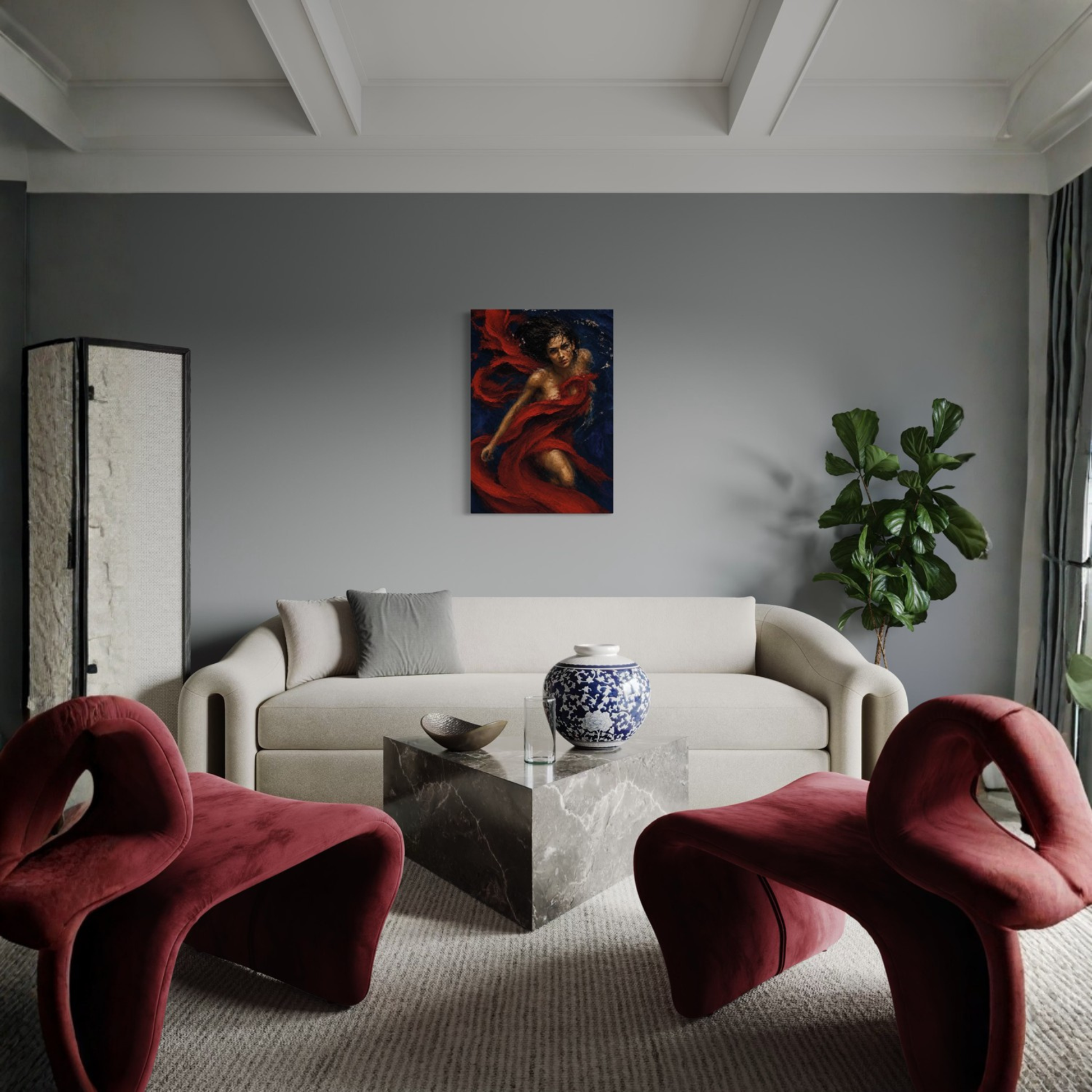 A modern living room with a gray wall, featuring the Crimson Undertow gallery-wrapped canvas hanging above a cream sofa. In front of the sofa is a marble-top coffee table with a blue and white ceramic vase, flanked by two sculptural burgundy chairs.