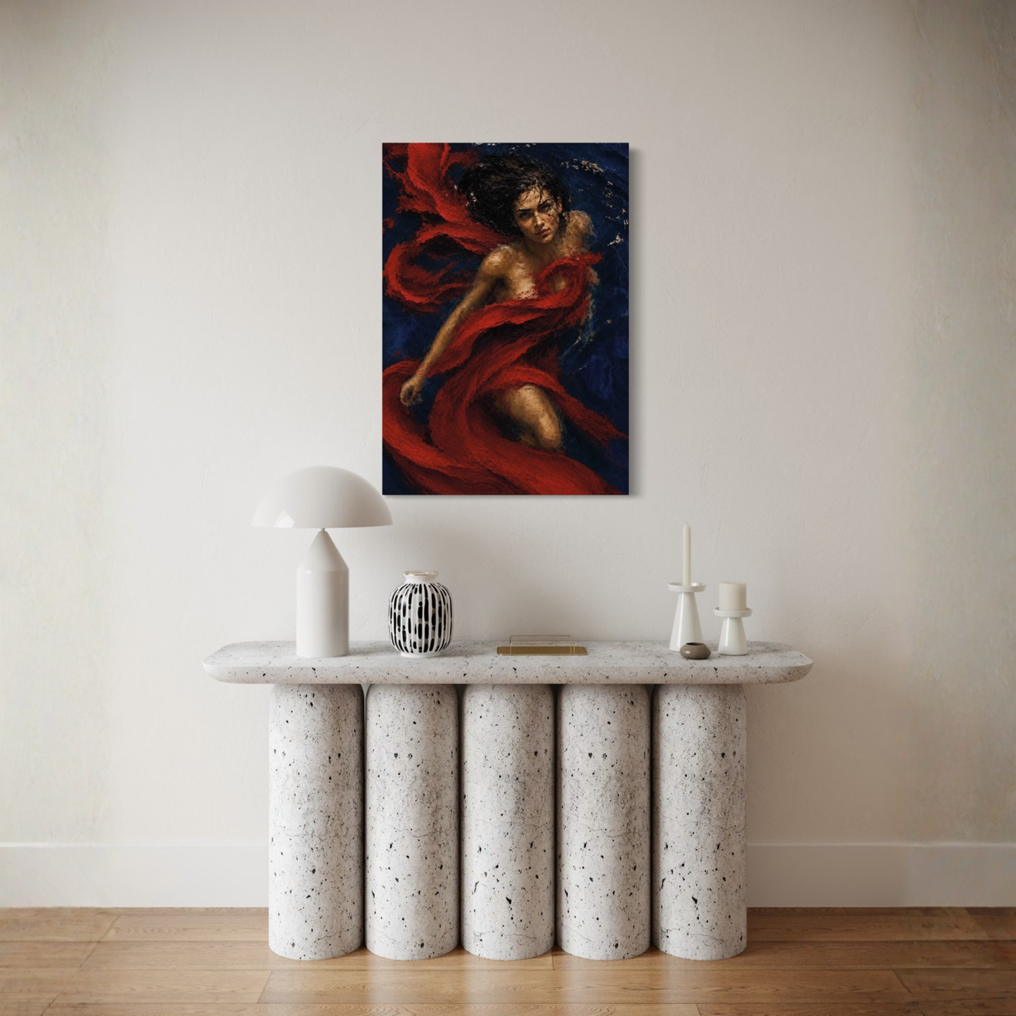 Crimson Undertow gallery-wrapped canvas displayed on a beige wall above a modern speckled stone console table with decorative objects.