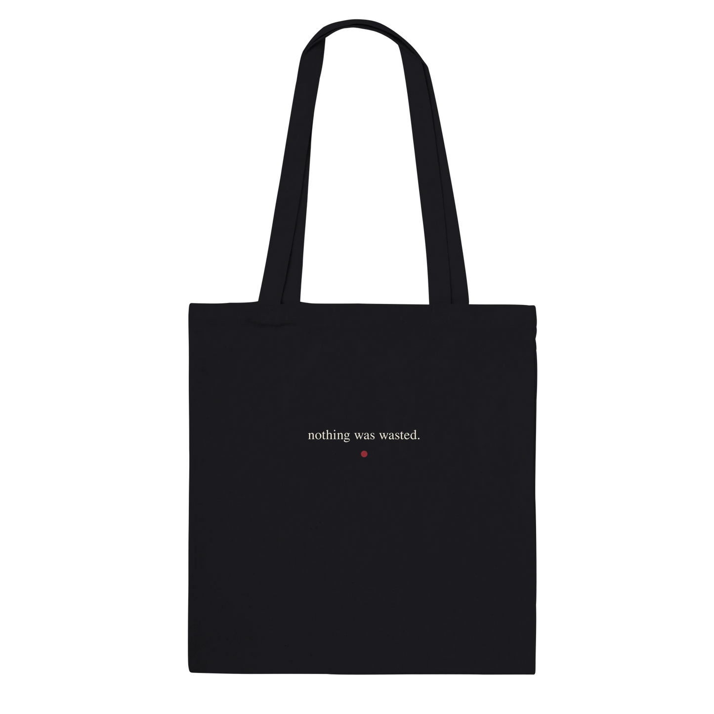 Back of THE MENDING black cotton tote featuring “nothing was wasted.” in small ivory serif lettering.