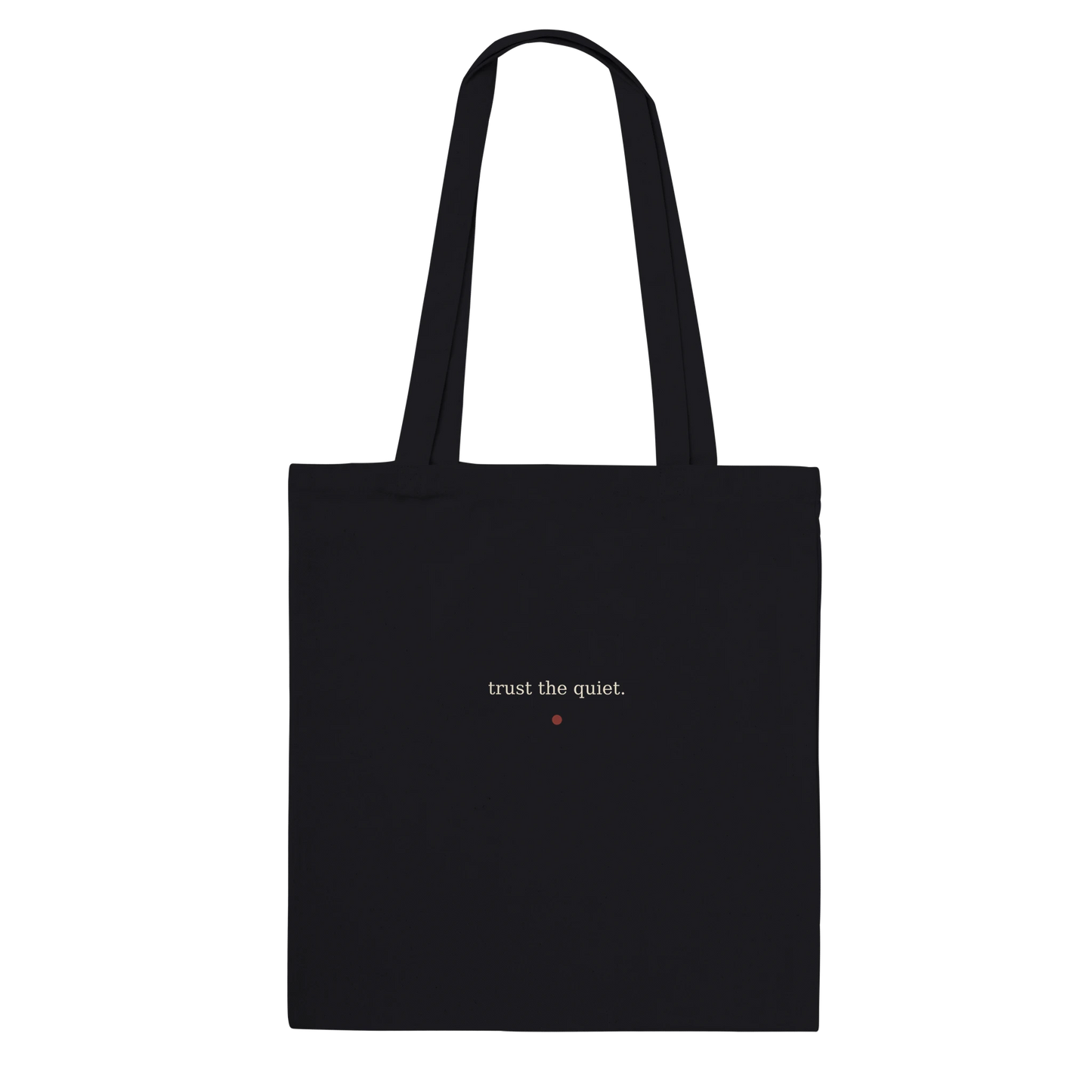 Back of THE LISTENING black cotton tote featuring the words trust the quiet in warm-ivory serif lettering.