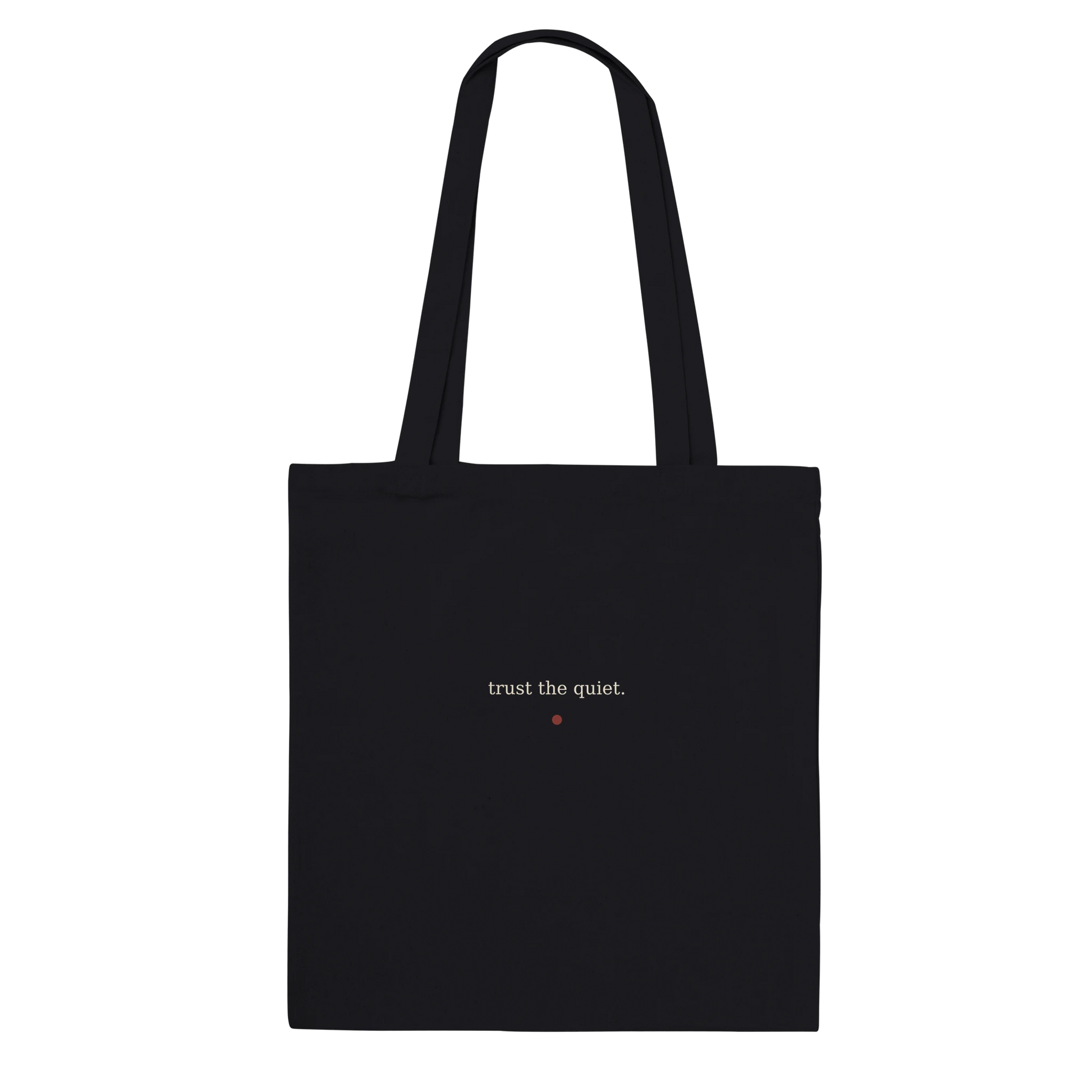 Back of THE LISTENING black cotton tote featuring the words trust the quiet in warm-ivory serif lettering.