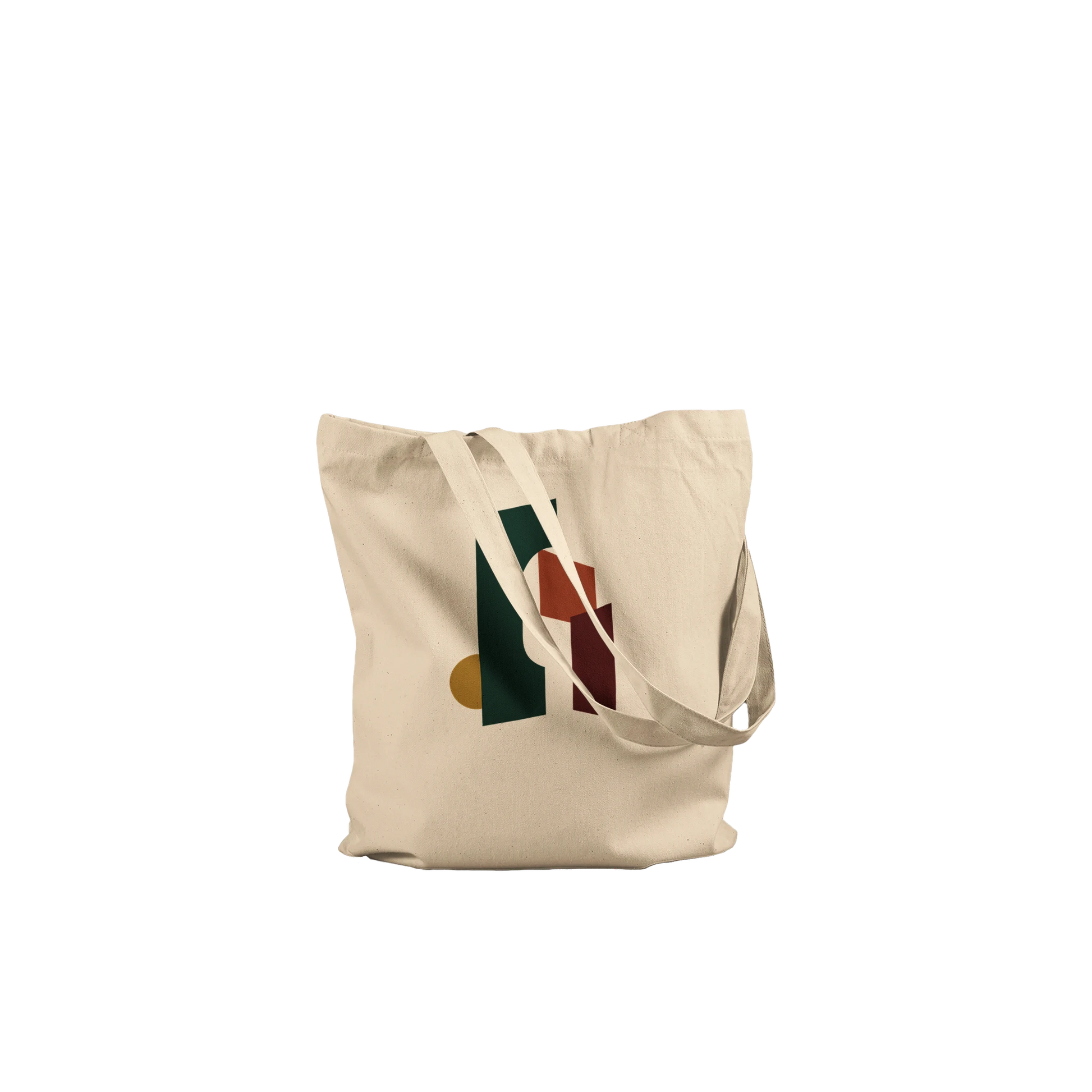 Folded THE THRESHOLD natural cotton tote showing its forest-green, rust and burgundy abstract artwork.