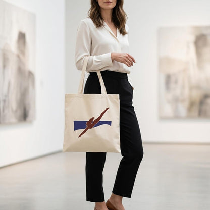 Woman carrying THE PULL figurative art tote inside a contemporary gallery.